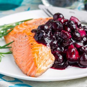 Salmon filet with blueberry sauce topping