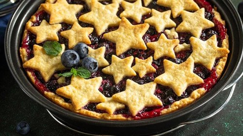 multiple stars cut out of dough top a blueberry cobbler